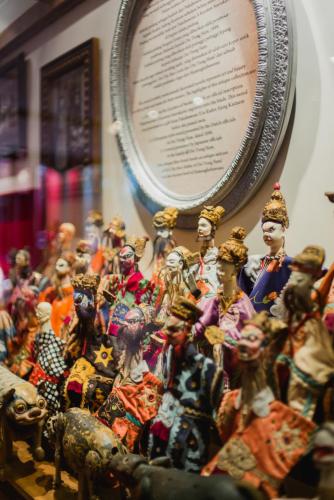 a group of figurines sitting next to a plate at Hotel Tugu Malang in Malang