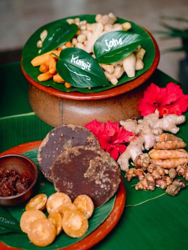 two plates of food on top of a table at Hotel Tugu Malang in Malang