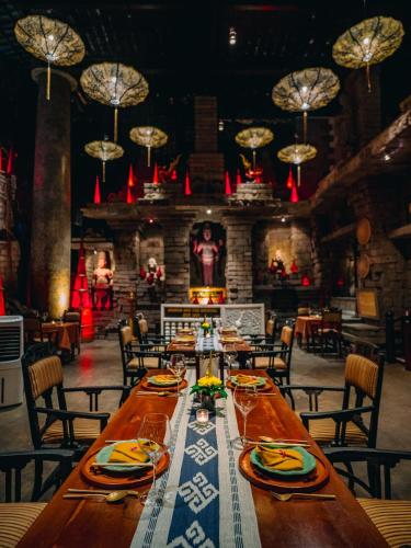 a dining room with a long table and chairs at Hotel Tugu Malang in Malang