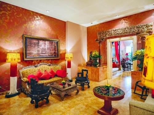 a living room with a couch and a table at Hotel Tugu Malang in Malang