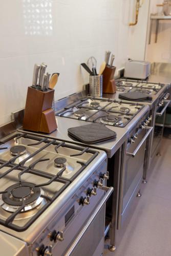 a row of stove tops in a kitchen at Spin Off Hostel in Perth