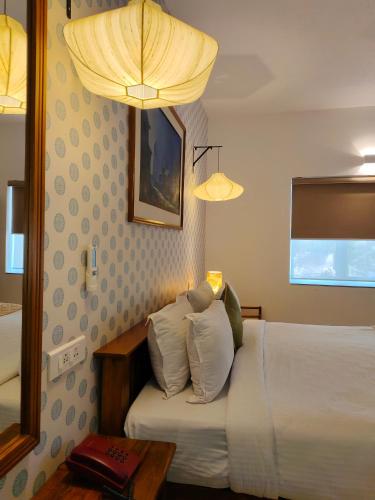 Postel nebo postele na pokoji v ubytování Hotel Aura by Woco Stays