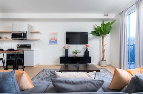 a living room with a couch and a table at Large Victorian Sleeps 6 by UofT in Toronto