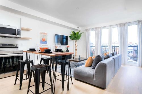 a kitchen and living room with a couch and a table at Large Victorian Sleeps 6 by UofT in Toronto