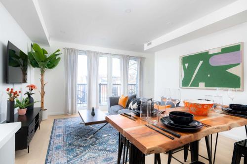 a living room with a table and a couch at Large Victorian Sleeps 6 by UofT in Toronto