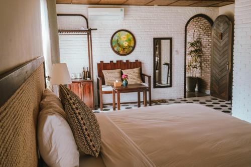 a bedroom with a bed and a living room at Hoi An Ti Hon House in Hoi An