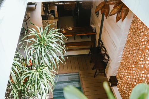 an overhead view of a balcony with plants and a table at Hoi An Ti Hon House in Hoi An