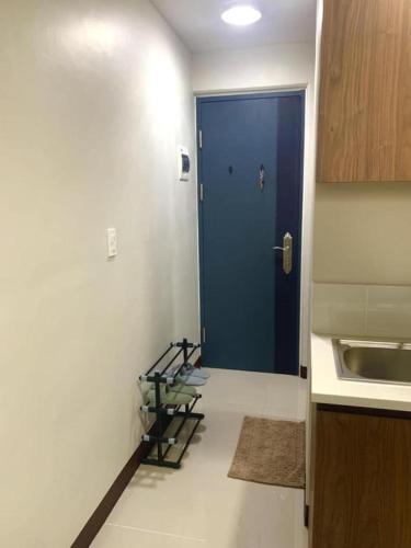 a hallway with a blue door in a kitchen at Jack Cabin in Lapu Lapu City