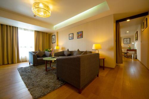 a living room with a couch and a table at Classic Grande,a Member of Radisson in Imphal
