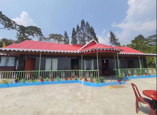a house with a red roof at Nivvana Homestay By StayApart in Lava