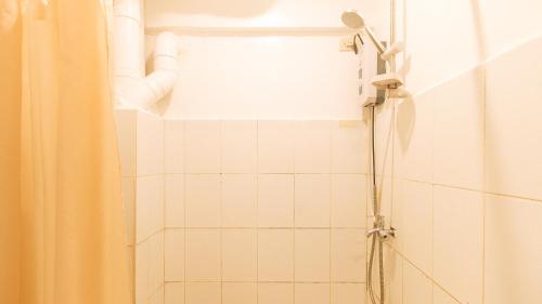 a shower with a shower curtain in a bathroom at RedDoorz at City Stay Inns Marilao in Lias