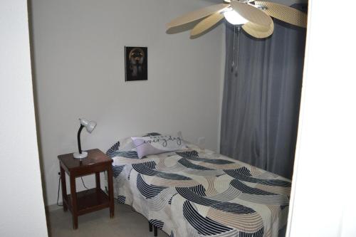 een slaapkamer met een bed en een tafel met een lamp bij Casa Lulu junto a Queretaro in Villa Apaseo