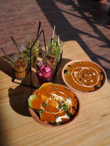 a table with two plates of food on a table at Yes Hotel By The Ganges in Rishīkesh