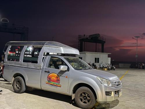 a white truck parked in a parking lot at Baan Plai Laem Homestay at Koh Paluay in Koh Phaluai