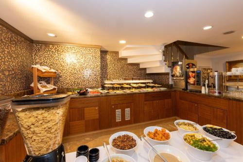 a kitchen with many bowls of food on a counter at Aven Hotel in Istanbul