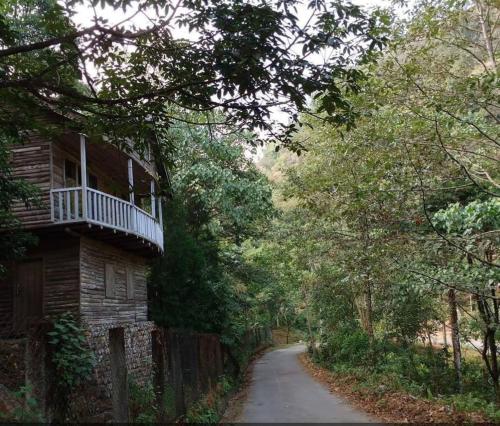 a house with a balcony on the side of a road at Aranya Baas By StayApart in Sukhia Pokhari