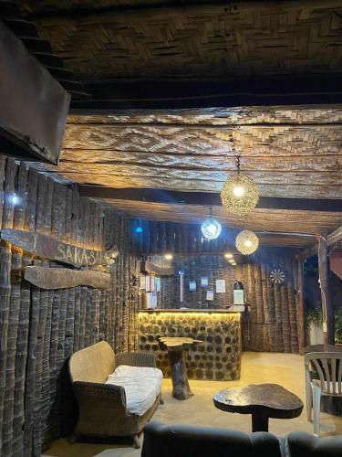 a living room with a couch and a table at Sakâ Sakâ Beach House in Sipalay