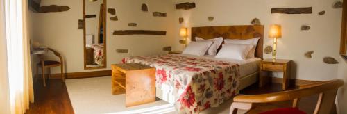 um quarto com uma cama e uma mesa em uma sala em Refgios do Pinhal em Oleiros