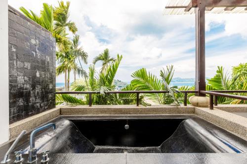a bath tub with a view of the ocean at Seaview Villa Yang Som at Surin Beach in Thalang