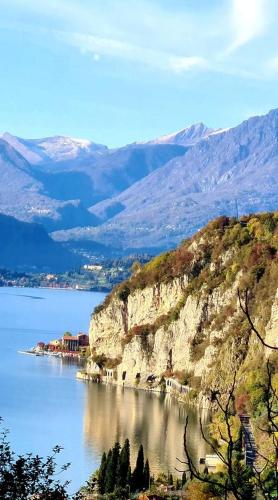 a large body of water next to a mountain at B&B Le Ortensie -Lago di Como in Lierna