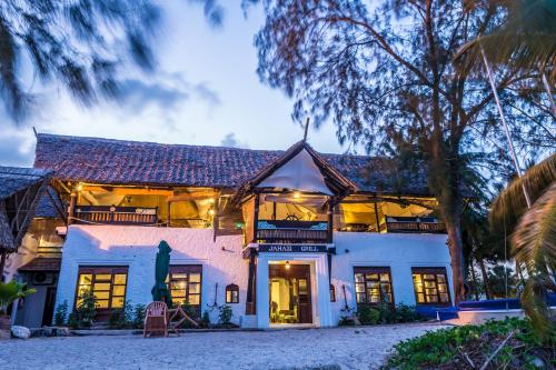 an exterior view of a white house at Serena Beach Resort & Spa in Mombasa