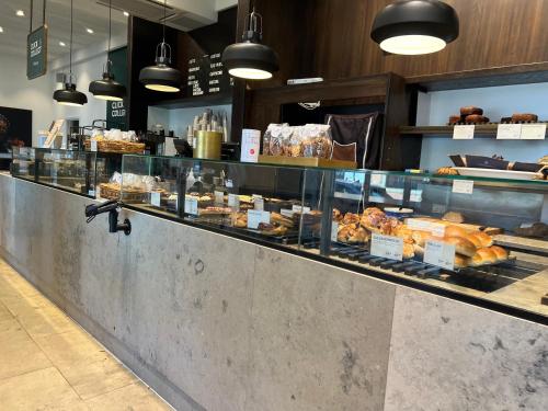 a bakery counter with a lot of pastries at Copenhagen City Luxe Retreat in Copenhagen
