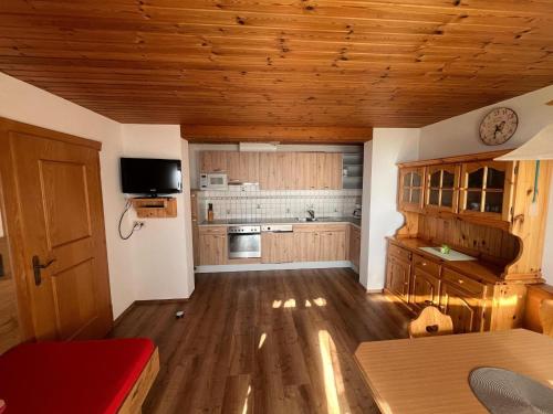 a large kitchen with wooden floors and wooden ceilings at Apartment in Hippach near Horbergbahn in Mühlen