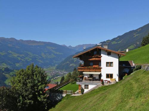 a house on a hill with mountains in the background at Apartment in Hippach near Horbergbahn in Mühlen