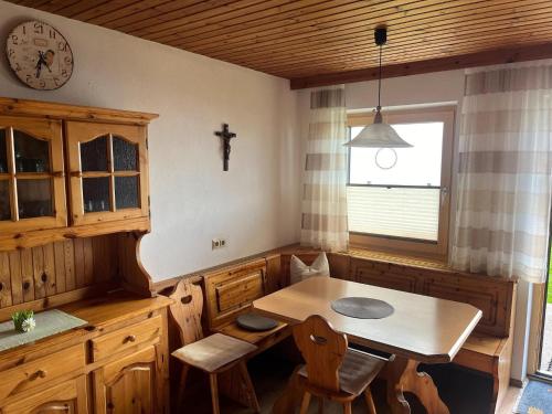 a kitchen with a table and chairs and a clock at Apartment in Hippach near Horbergbahn in Mühlen