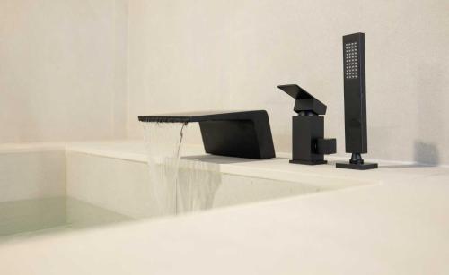 a bathroom with a water fountain and a tv at Aank Hotel and Spa Jongno Unni in Seoul