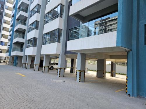 an empty parking lot in front of a building at Ideal Homes, 3 Bedrooms in Nairobi