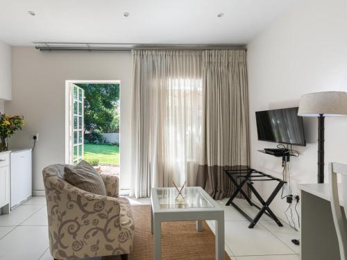 a living room with a couch and a table at Emmarentia Guest House in Johannesburg