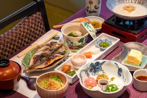a table topped with plates and bowls of food at Hakone Kamon in Hakone