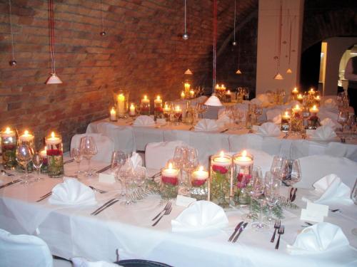 a group of tables with white table cloths and candles at Hotel Alt Speyer in Speyer