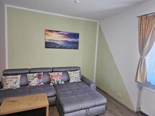 a living room with a couch and a table at Ferienwohnung Katharina in Steinbach am Attersee