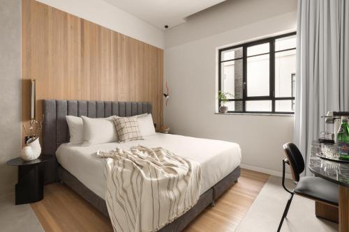 a bedroom with a bed and a window at Hotel Bazaar - Fattal Colors in Tel Aviv