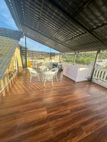 a balcony with a table and chairs on a deck at Abode 3-2 bhk attic private terrace Siolim Marna in Camorlim