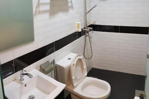 a bathroom with a toilet and a sink at Jenjarom Boutique Hotel in Banting
