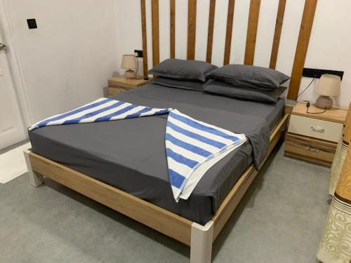 a bedroom with a bed with a wooden frame at La Luna Boutique Dhangethi in Dhangethi