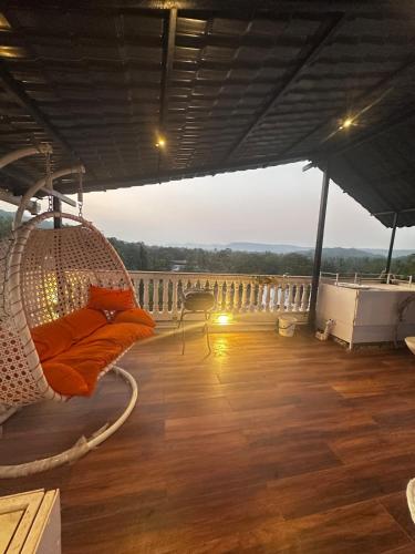 a porch with a hanging hammock on a balcony at Abode 3-2 bhk attic private terrace Siolim Marna in Camorlim