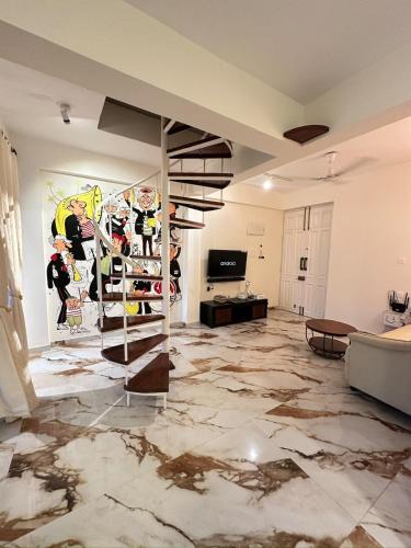a living room with a marble floor and a staircase at Abode 3-2 bhk attic private terrace Siolim Marna in Camorlim