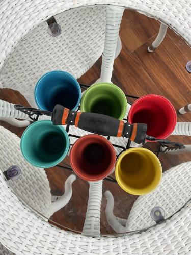 a group of different colored cups on a table at Abode 3-2 bhk attic private terrace Siolim Marna in Camorlim