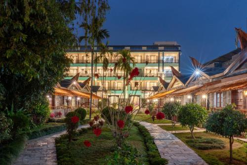 a building with a garden in front of it at Lake View Resort in Pokhara