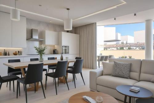 a living room with a couch and a table and chairs at Seaview Luxury Villa Jacuzzi & Pool! 2 Min Beach in Protaras