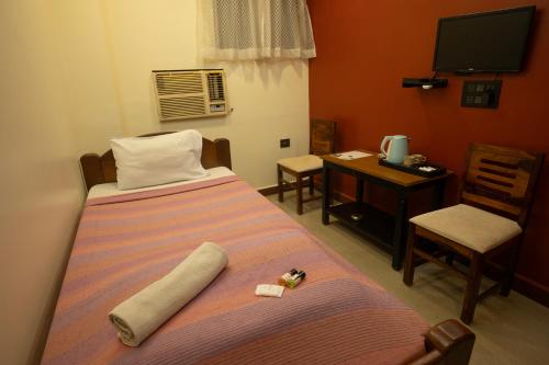 Postel nebo postele na pokoji v ubytování Hotel Suncity