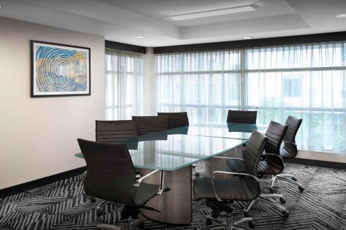 a conference room with a glass table and chairs at Hyatt Place Boulder Pearl Street - Newly Renovated in Boulder
