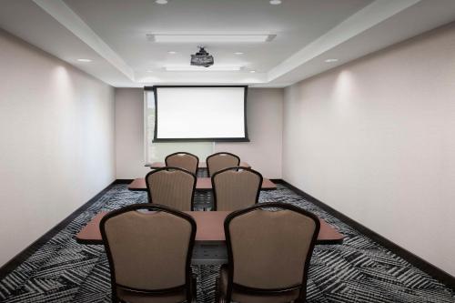a meeting room with chairs in front of a projection screen at Hyatt Place Boulder Pearl Street - Newly Renovated in Boulder