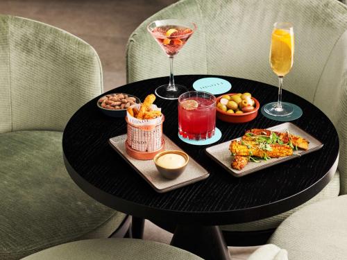 a black table with food and drinks on it at Hyatt House London Stratford - Aparthotel in London