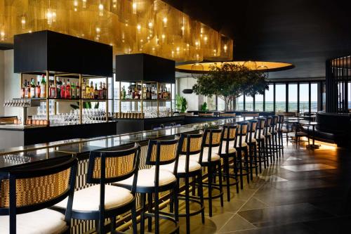a bar with a row of chairs in a restaurant at Homewood Suites By Hilton Raleigh Downtown in Raleigh