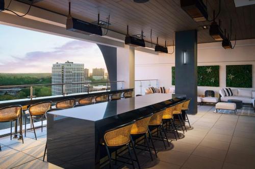 a bar on the roof of a building with chairs at Homewood Suites By Hilton Raleigh Downtown in Raleigh